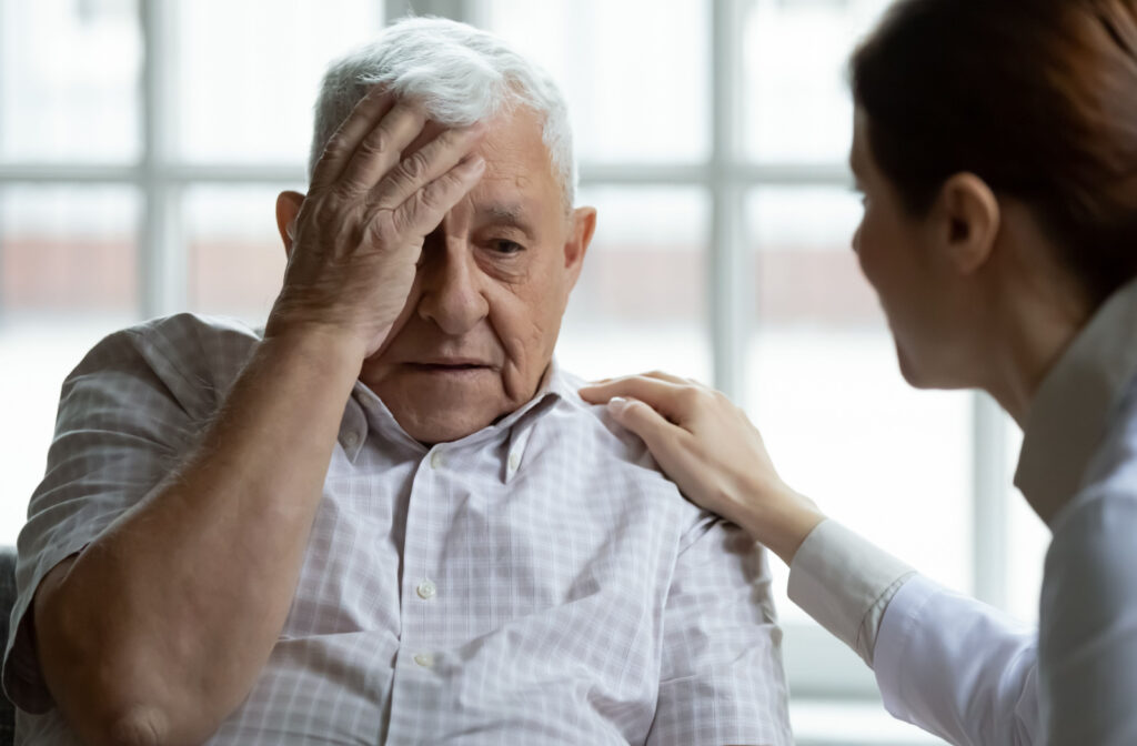 A caregiver talking to an senior man who is experiencing disorientation and confusion.