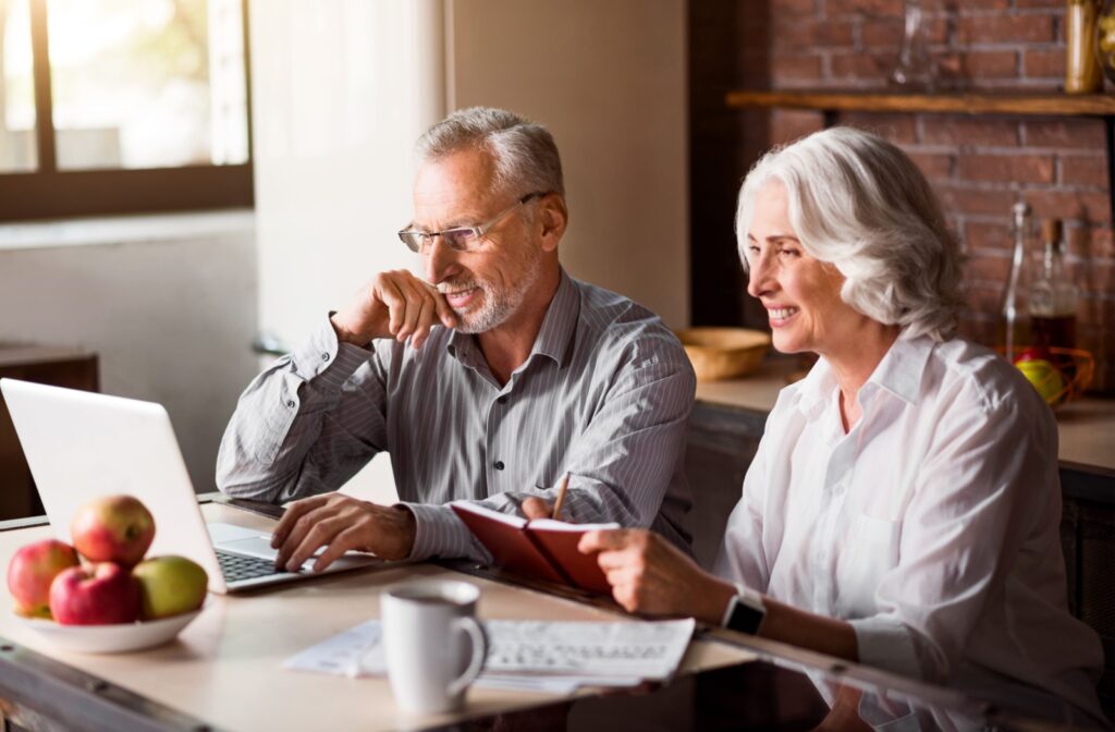 An older married couple sitting in their kitchen with a laptop and notebook trying to choose their future senior living community. Dan Hendrikx Dan Hendrikx 10:40 AM Nov 25 An adult visiting their older parents in senior living, smiling and hugging each other on the couch.