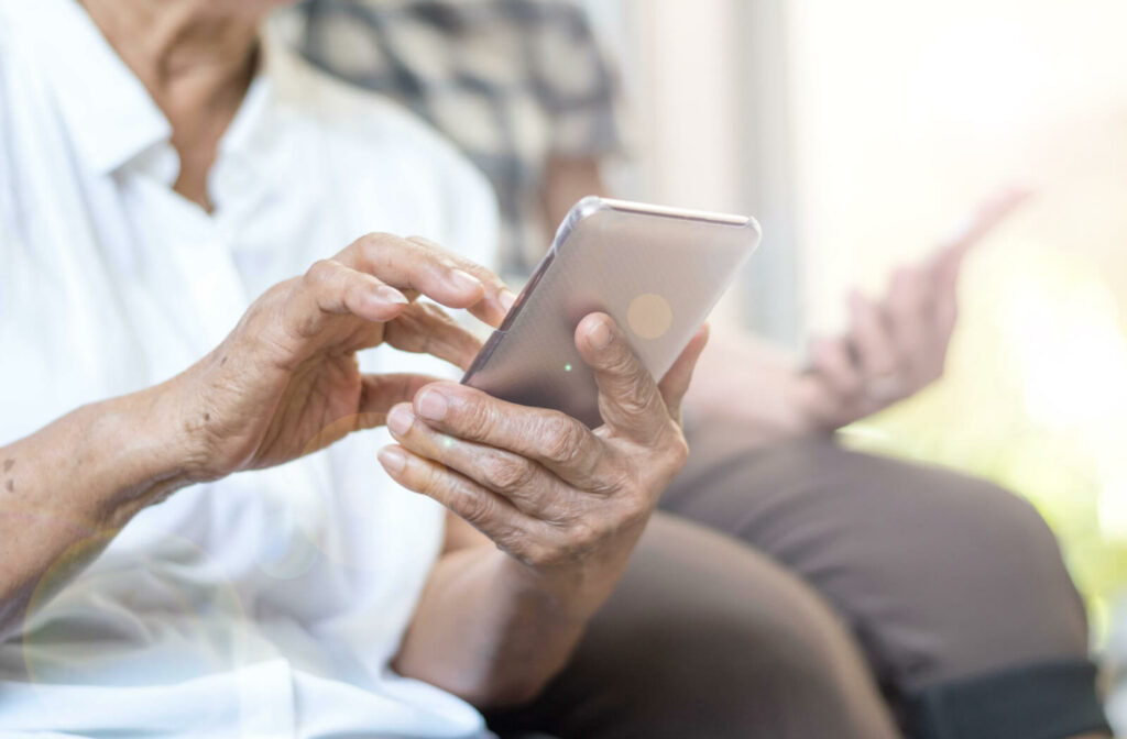 A close-up image of two older adults using their new cell phones